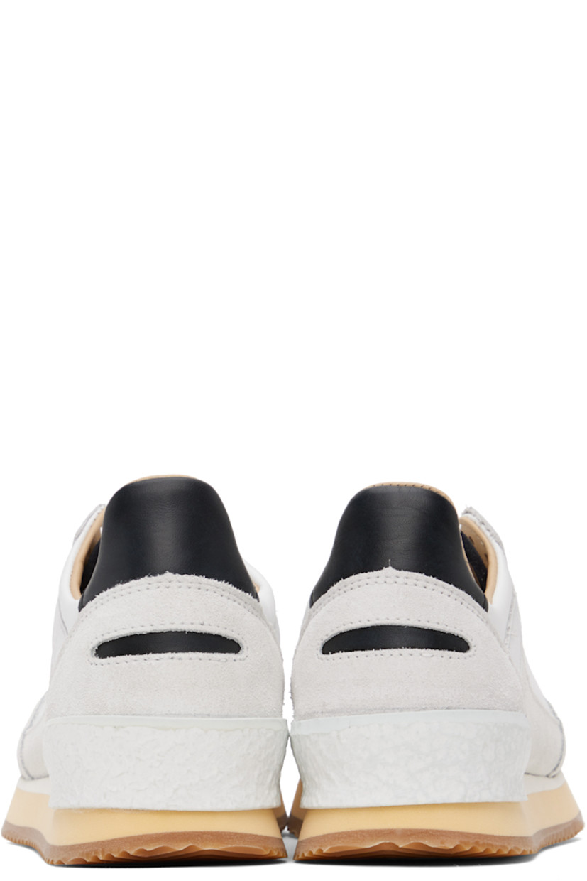 Low-top paneled buffed leather and suede sneakers in white and gray. 

· Perforated detailing at toe
· Lace-up closure
· Logo patch at tongue
· Padded collar
· Logo engraved at outer side
· Textured rubber trim at heel counter
· Stacked foam rubber midsole
· Treaded rubber sole 

Supplier color: White