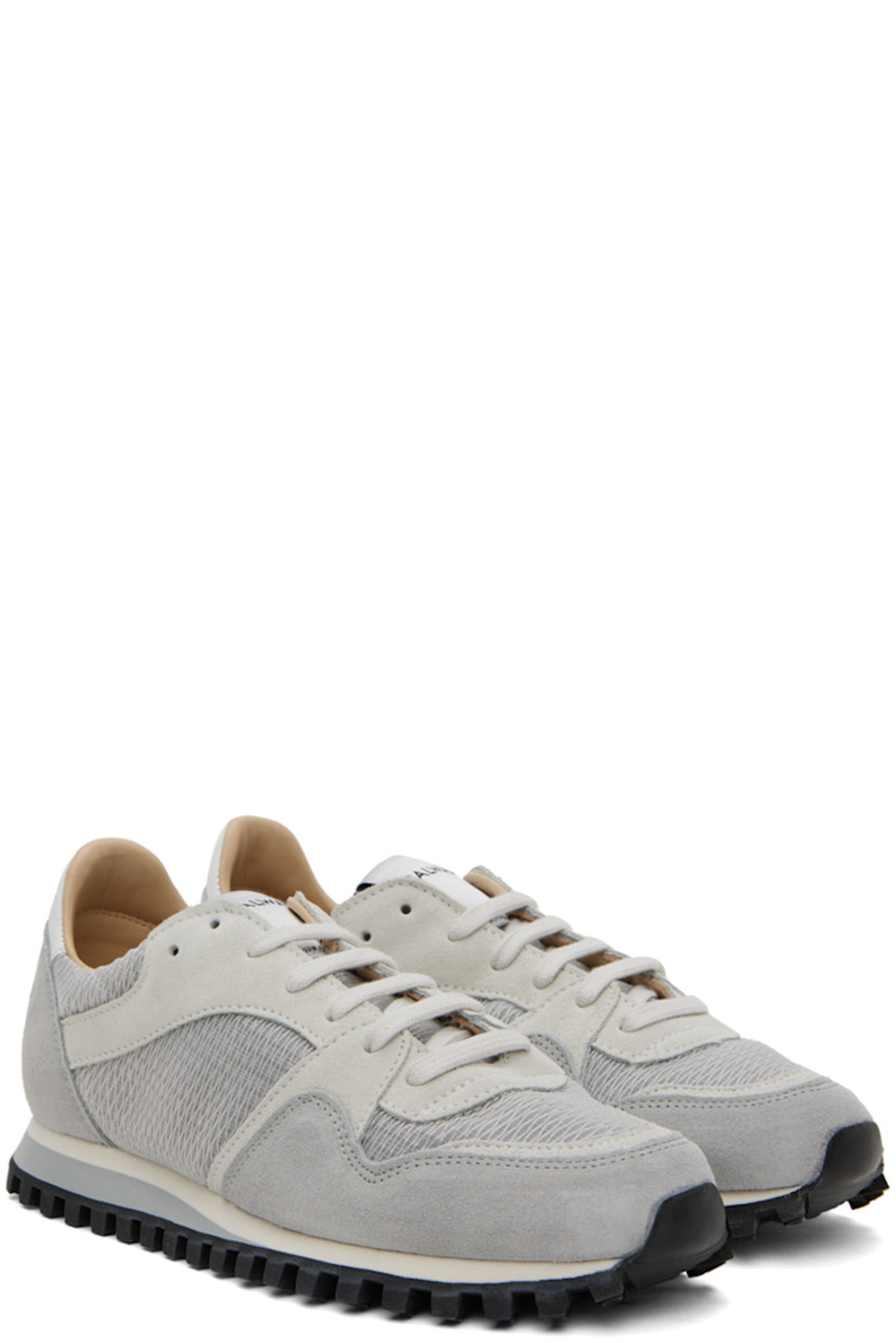 Low-top paneled mesh, suede, and buffed leather sneakers in tones of gray.

· Lace-up closure
· Logo patch at padded tongue
· Padded collar
· Buffed leather and mesh lining 
· Stacked foam rubber midsole
· Treaded rubber sole

Supplier color: Grey