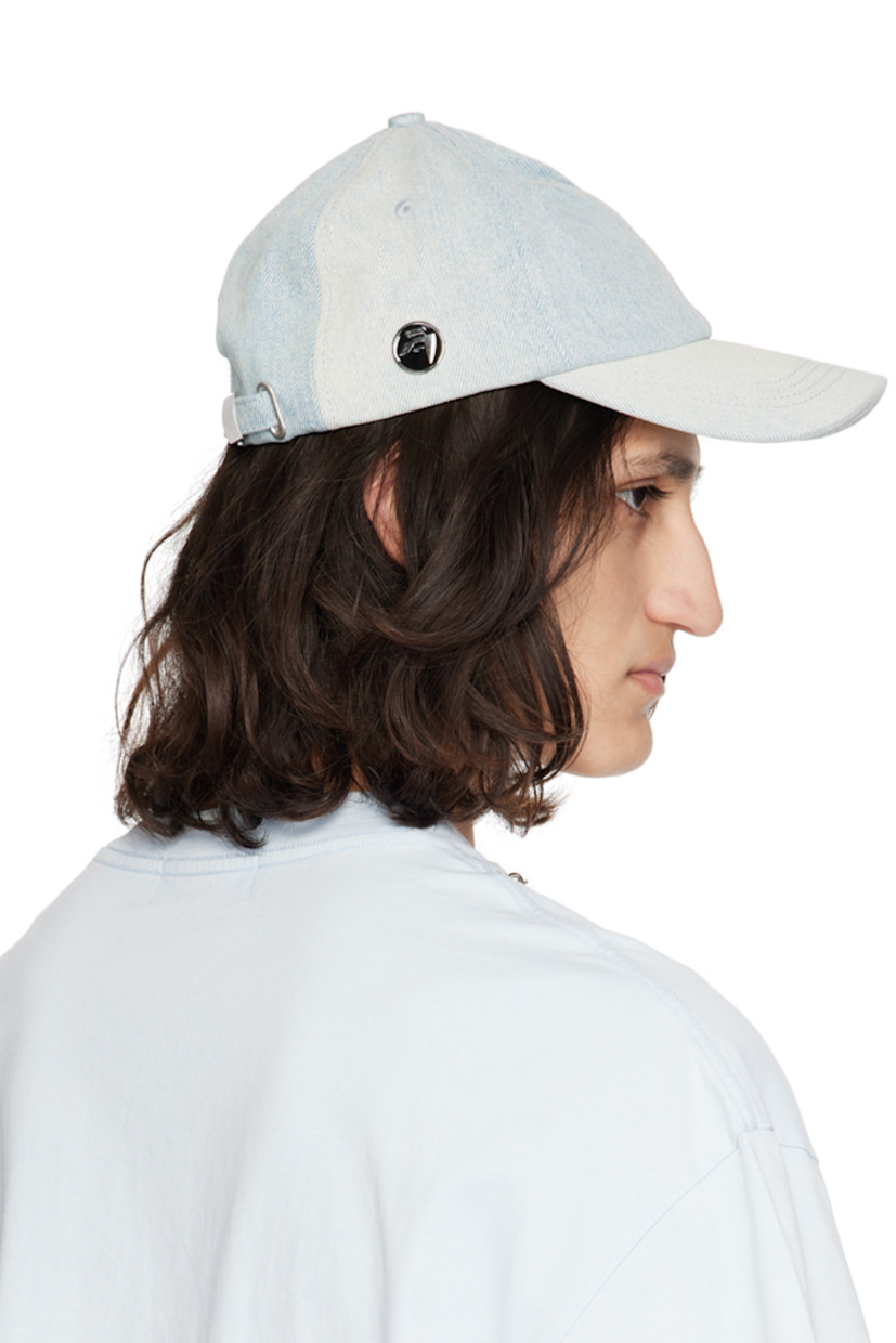 Non-stretch denim cap in blue. Fading throughout. 

· Embroidered eyelets at crown 
· Curved brim
· Enameled logo hardware at side 
· Cinch fastening at back 
· Twill browband 
· Full plain-woven lining 

Supplier color: Light blue
