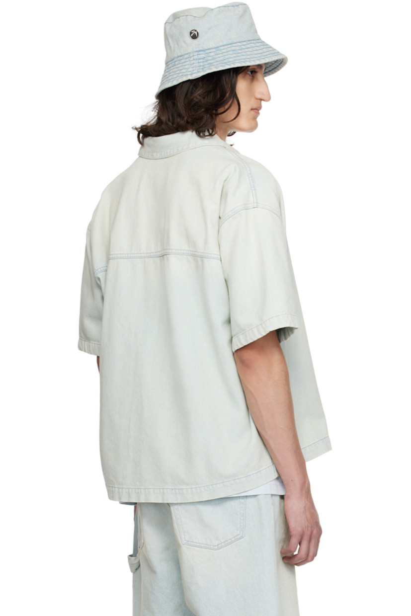 Non-stretch denim shirt. Fading throughout.

· Spread collar
· Concealed press-stud closure
· Logo hardware at patch pocket
· Shirttail hem
· Single-press-stud barrel cuffs
· Contrast stitching in gray

Supplier color: Light blue
