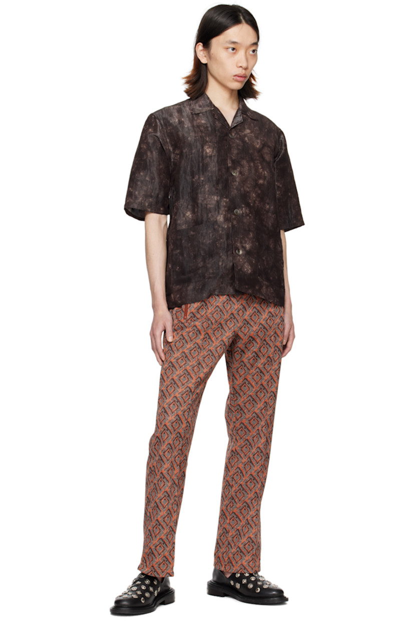 Nylon- and rayon-blend sateen shirt. Graphic pattern printed throughout.

· Open spread collar
· Button closure
· Patch pockets

Supplier color: Brown