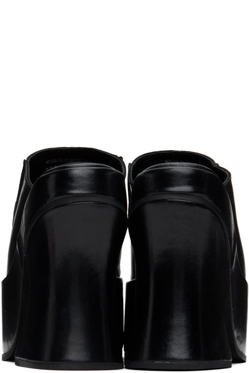 Grained leather mules in black.

· Open square toe
· Pinched seams at vamp
· Logo embossed at padded footbed
· Covered block heel 
· Platform midsole
· Foam rubber sole
· Platform: H2.25" 
· Heel: H5"

Supplier color: Black