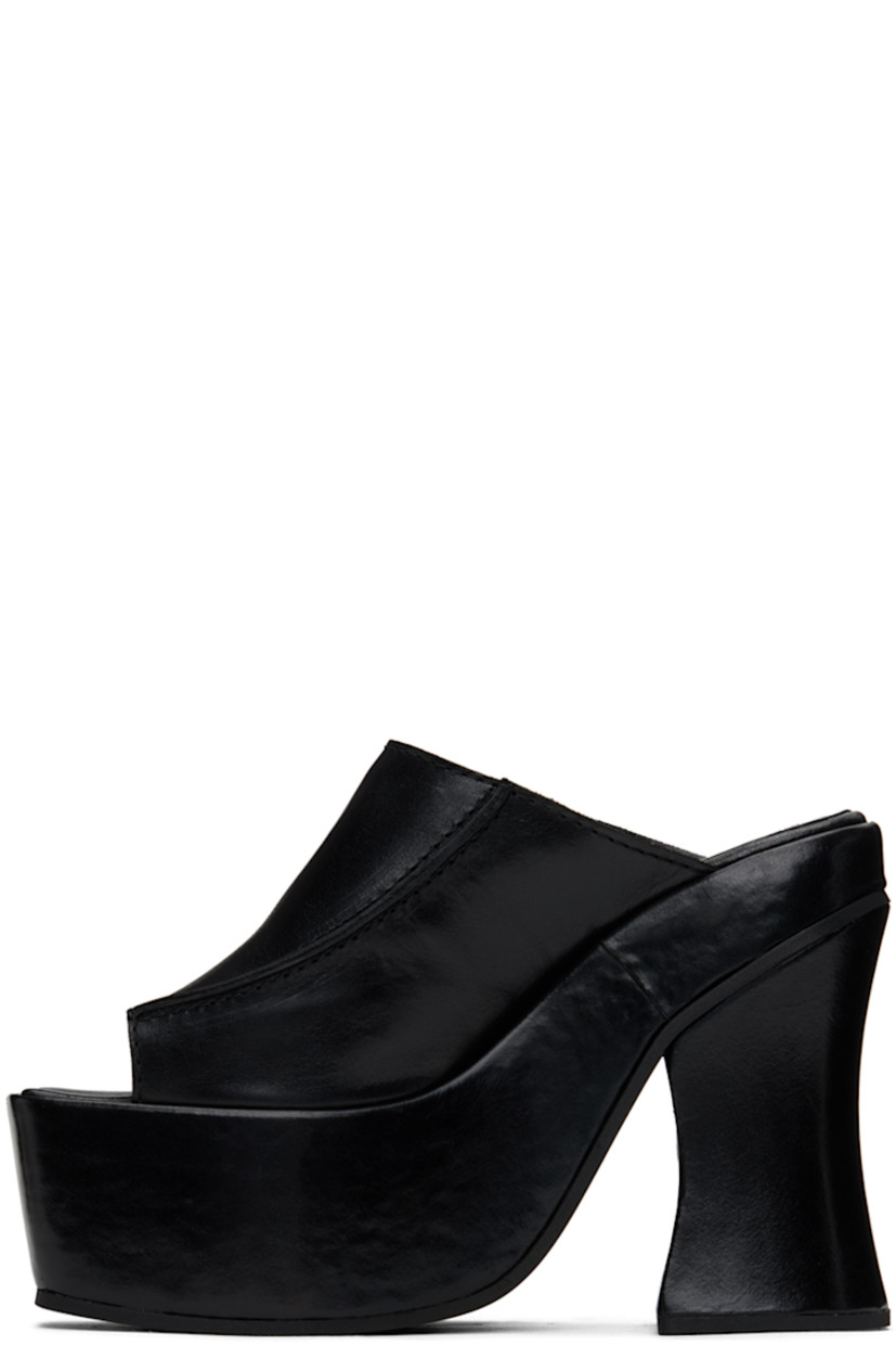 Grained leather mules in black.

· Open square toe
· Pinched seams at vamp
· Logo embossed at padded footbed
· Covered block heel 
· Platform midsole
· Foam rubber sole
· Platform: H2.25" 
· Heel: H5"

Supplier color: Black