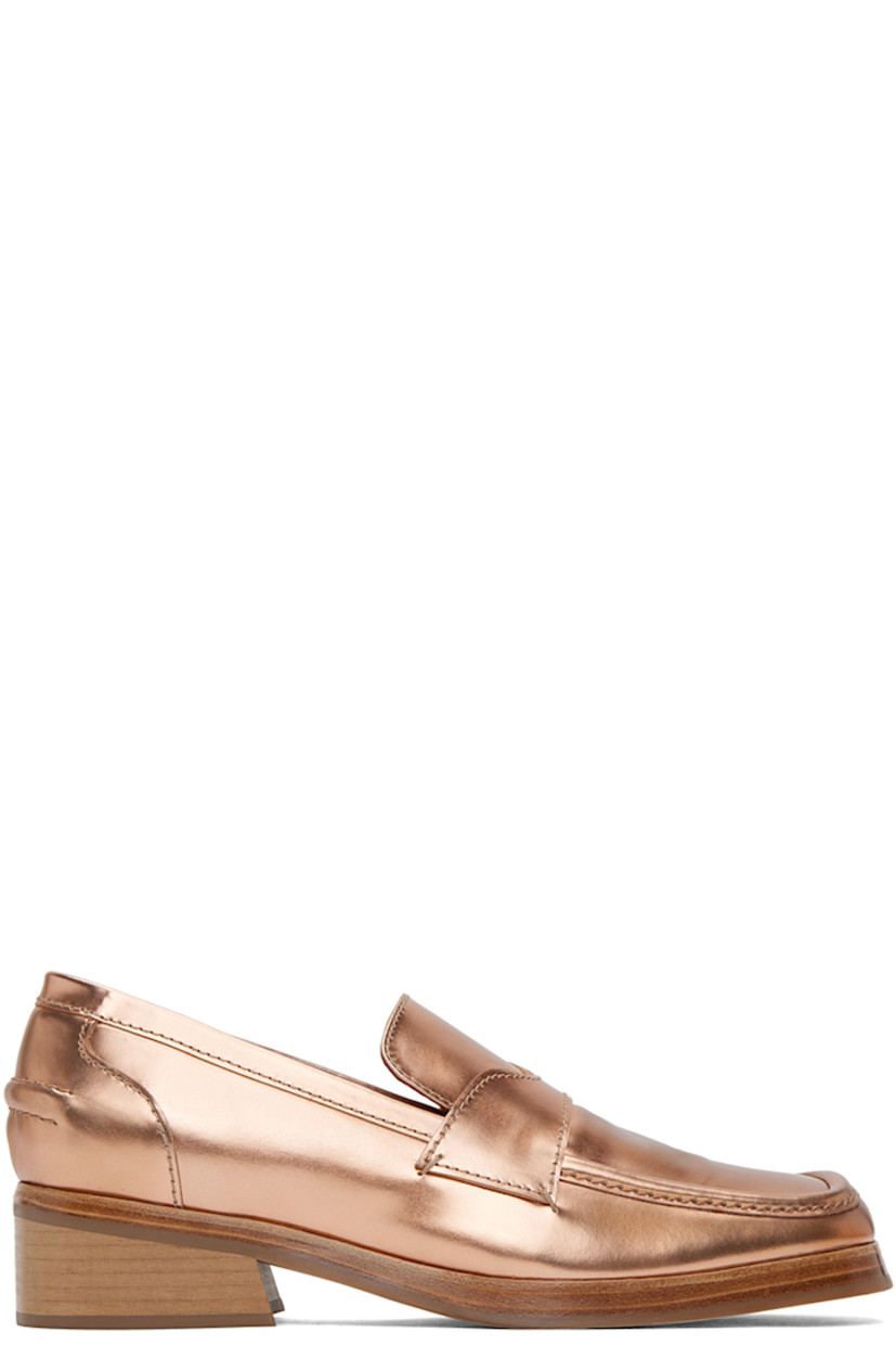 Polished leather slip-on loafers in copper-tone.

· Square toe
· Strap at vamp
· Logo-embossed padded leather footbed
· Grained leather lining 
· Stacked leather block heel
· Rubber sole
· Heel: H1.25"

Supplier color: Brown