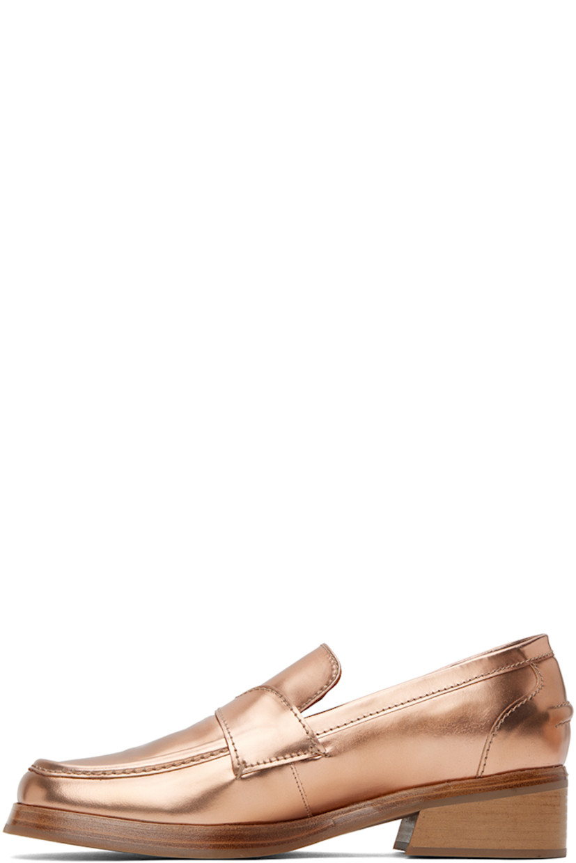 Polished leather slip-on loafers in copper-tone.

· Square toe
· Strap at vamp
· Logo-embossed padded leather footbed
· Grained leather lining 
· Stacked leather block heel
· Rubber sole
· Heel: H1.25"

Supplier color: Brown