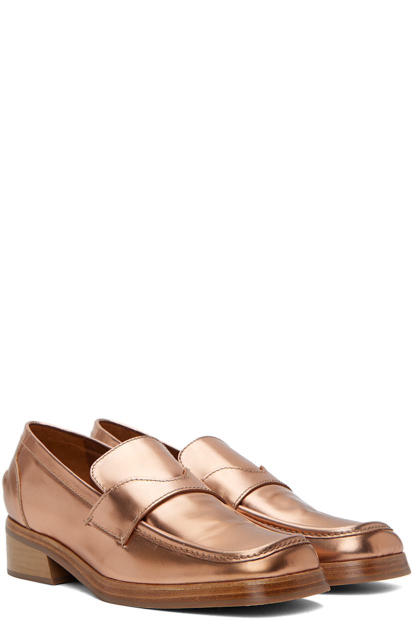 Polished leather slip-on loafers in copper-tone.

· Square toe
· Strap at vamp
· Logo-embossed padded leather footbed
· Grained leather lining 
· Stacked leather block heel
· Rubber sole
· Heel: H1.25"

Supplier color: Brown