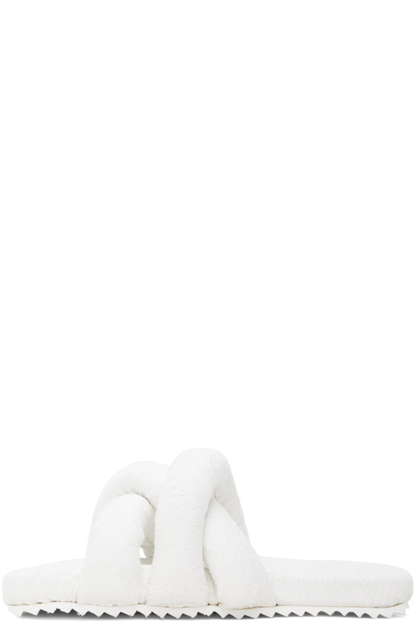 Padded brocade slip-on sandals in white.

· Jacquard graphic pattern throughout
· Open square toe
· Criss-crossing straps at vamp
· Logo embossed at EVA foam footbed
· Treaded rubber sole

Supplier color: White