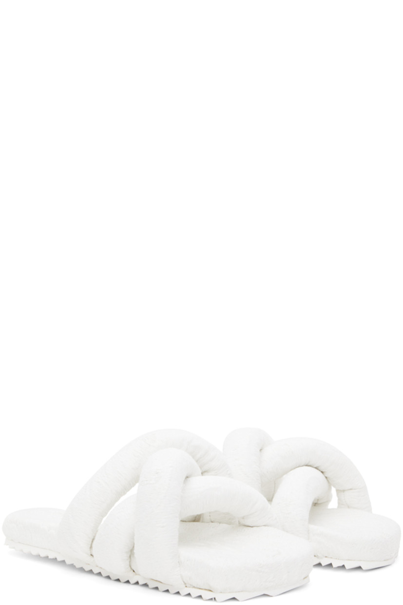 Padded brocade slip-on sandals in white.

· Jacquard graphic pattern throughout
· Open square toe
· Criss-crossing straps at vamp
· Logo embossed at EVA foam footbed
· Treaded rubber sole

Supplier color: White