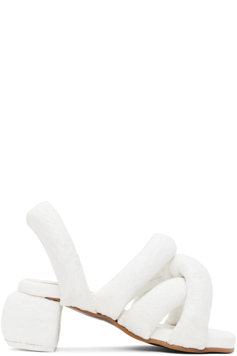 Padded brocade heeled sandals in white.

· Jacquard graphic pattern throughout
· Open square toe
· Criss-crossing straps at vamp
· Slingback strap
· Logo embossed at padded footbed
· Covered block heel with rubber injection
· Treaded rubber sole
· Heel: H2.5"

Supplier color: White