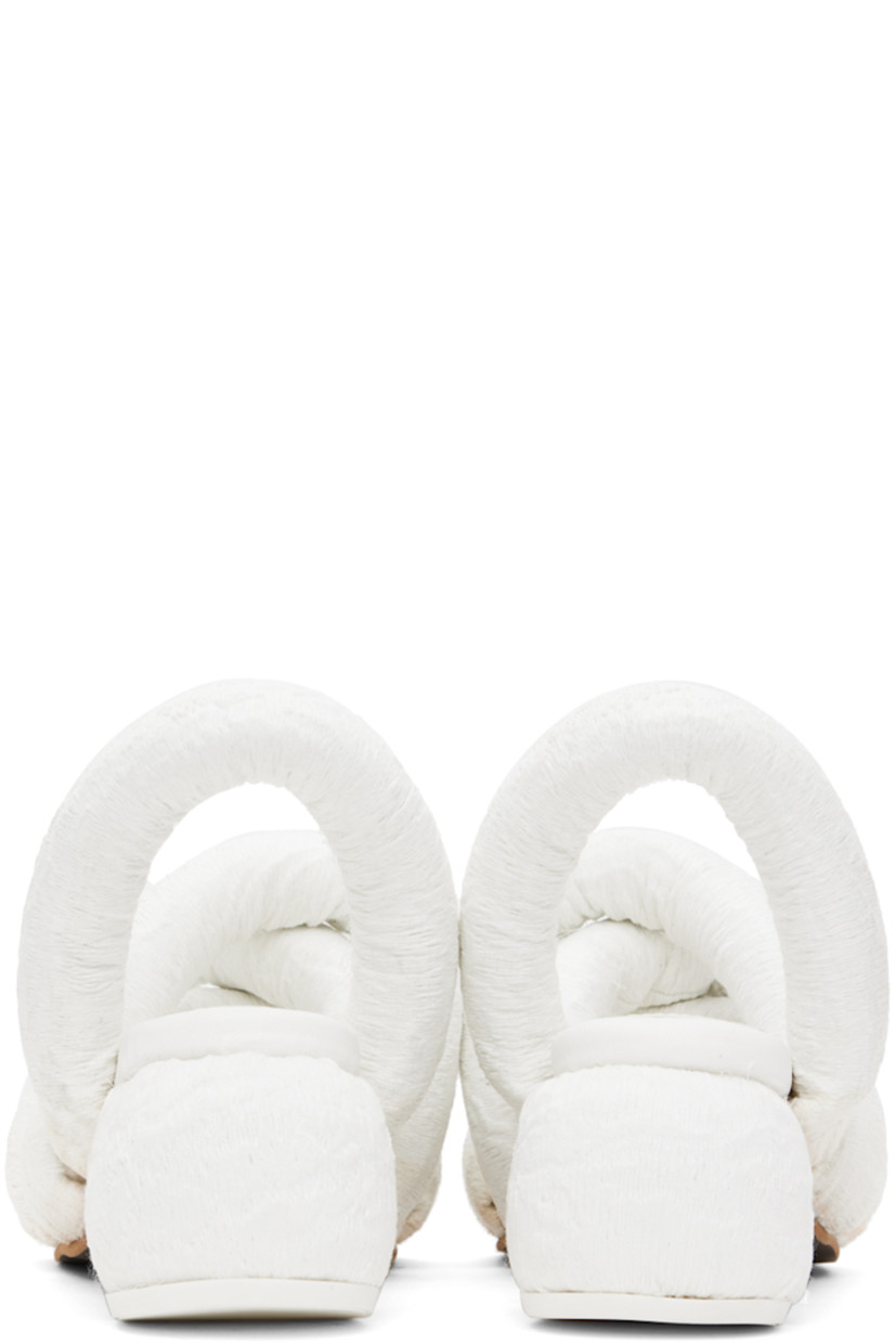 Padded brocade heeled sandals in white.

· Jacquard graphic pattern throughout
· Open square toe
· Criss-crossing straps at vamp
· Slingback strap
· Logo embossed at padded footbed
· Covered block heel with rubber injection
· Treaded rubber sole
· Heel: H2.5"

Supplier color: White