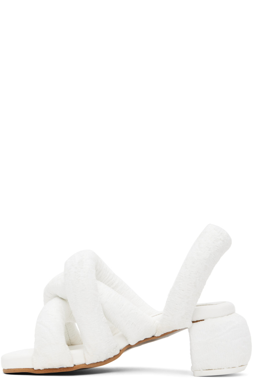 Padded brocade heeled sandals in white.

· Jacquard graphic pattern throughout
· Open square toe
· Criss-crossing straps at vamp
· Slingback strap
· Logo embossed at padded footbed
· Covered block heel with rubber injection
· Treaded rubber sole
· Heel: H2.5"

Supplier color: White