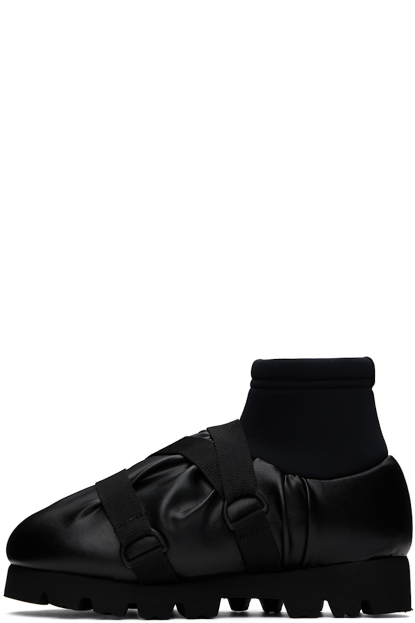 Ankle-high padded buffed faux-leather boots in black. 

· Gathering throughout
· Criss-crossing webbing cinch straps at vamp
· Logo flag at vamp
· Bonded jersey sock-style collar
· Pull-loop at heel collar
· Logo printed at padded footbed
· Jersey lining 
· EVA foam rubber platform midsole
· Treaded rubber sole
· Platform: H1.5"

Supplier color: Black