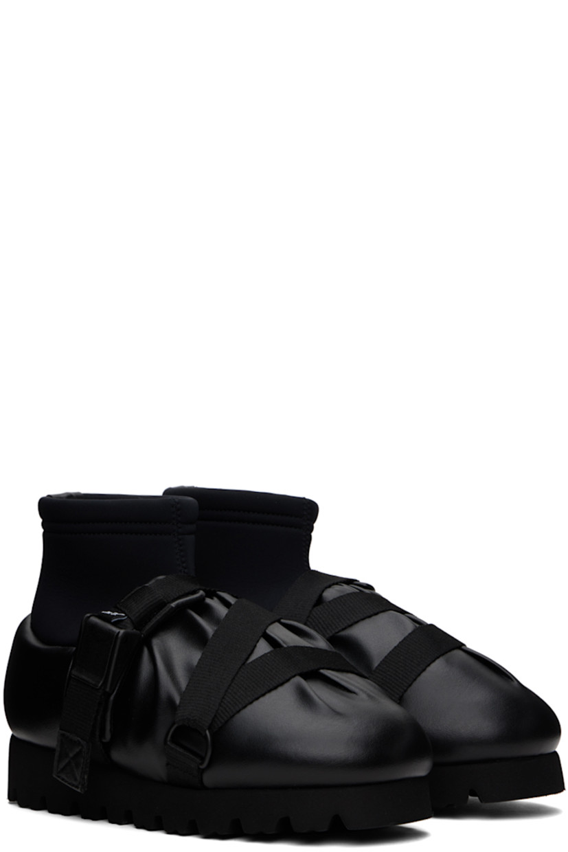 Ankle-high padded buffed faux-leather boots in black. 

· Gathering throughout
· Criss-crossing webbing cinch straps at vamp
· Logo flag at vamp
· Bonded jersey sock-style collar
· Pull-loop at heel collar
· Logo printed at padded footbed
· Jersey lining 
· EVA foam rubber platform midsole
· Treaded rubber sole
· Platform: H1.5"

Supplier color: Black