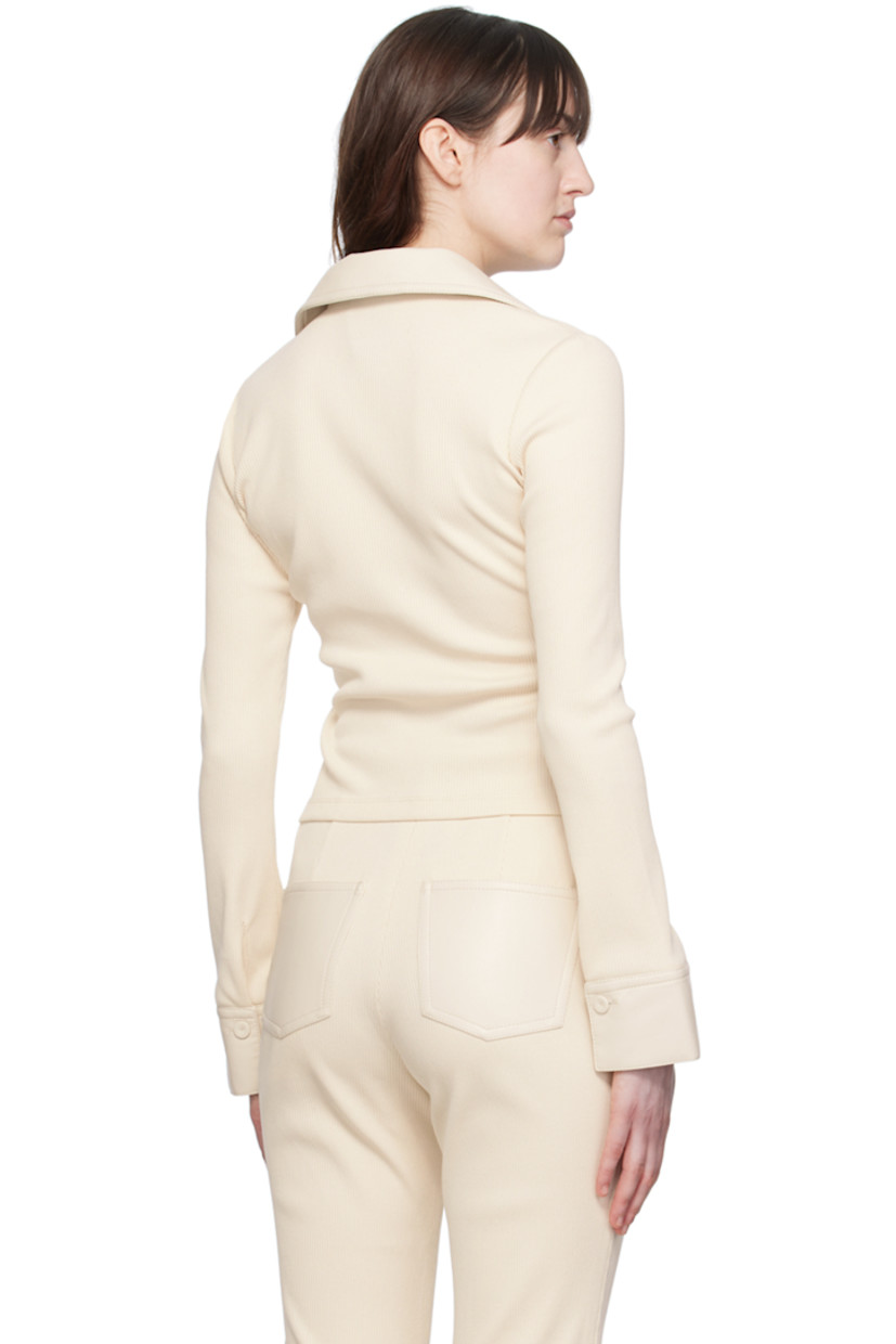 Organic cotton ribbed jersey shirt. Buffed regenerated leather trim throughout. 

· Open spread collar
· Button closure
· Mock flap pockets
· Single-button barrel cuffs
· Regenerated leather-covered hardware

Supplier color: Creme