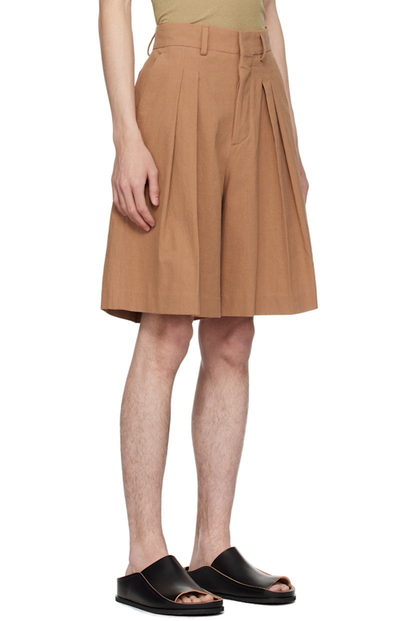 Wide-leg cotton seersucker shorts. 

· High-rise 
· Four-pocket styling
· Button-fly
· Pleats at front
· Partial plain-woven lining

Supplier color: Rust