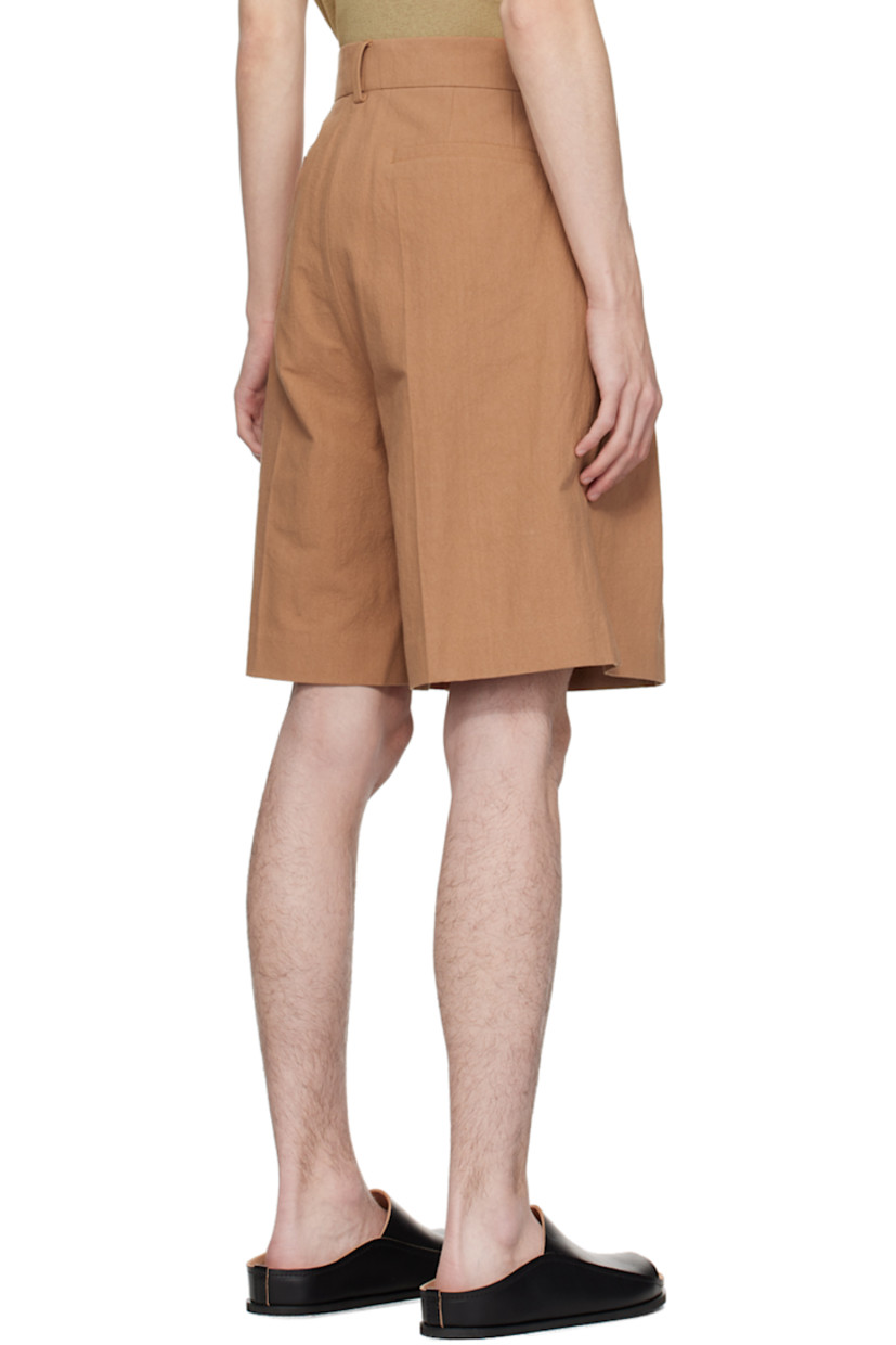 Wide-leg cotton seersucker shorts. 

· High-rise 
· Four-pocket styling
· Button-fly
· Pleats at front
· Partial plain-woven lining

Supplier color: Rust