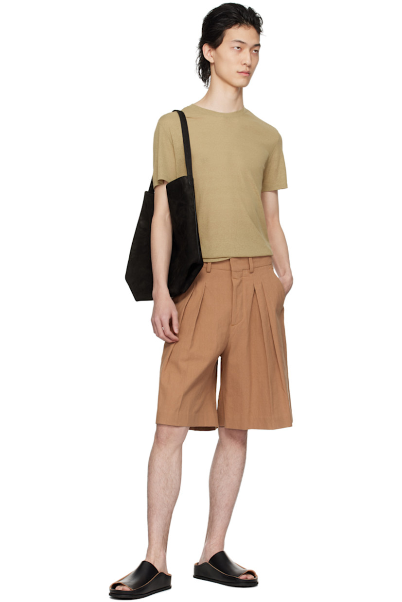 Wide-leg cotton seersucker shorts. 

· High-rise 
· Four-pocket styling
· Button-fly
· Pleats at front
· Partial plain-woven lining

Supplier color: Rust