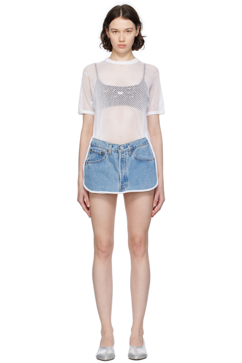 Cotton mesh and upcycled non-stretch denim dress. Rib knit trim and fading throughout. 

· Layered construction
· Crewneck
· Three-pocket styling 
· Zip-fly 
· Shirttail hem 
· Contrast stitching in tan 

Supplier color: Denim blue/White