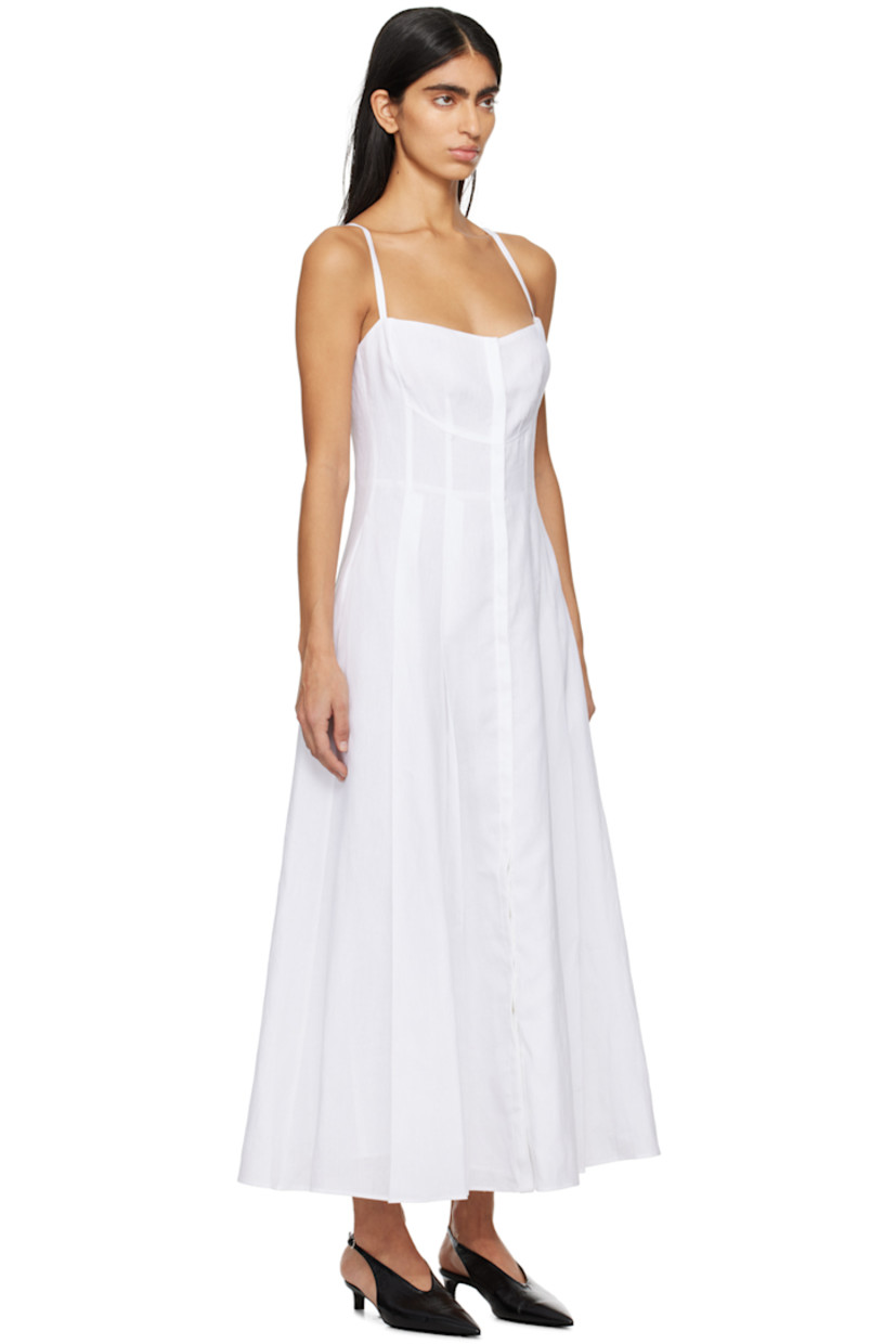 Plain-woven linen dress. 

· Sweetheart neck 
· Button closure 
· Pleated hem 
· Fixed shoulder straps 
· Full plain-woven cotton- and silk-blend lining 

Supplier color: White