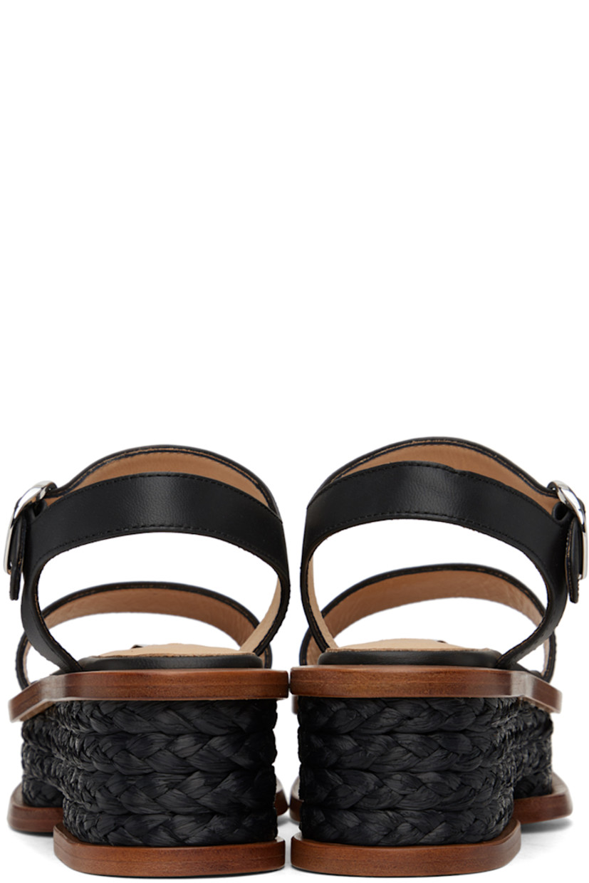 Handcrafted buffed nappa lambskin sandals in black. 

· Hand-woven raffia trim throughout 
· Open pointed toe
· Strap at vamp
· Pin-buckle ankle strap
· Logo patch at padded footbed
· Buffed calfskin lining
· Platform wood midsole 
· Polished leather sole
· Platform: H2.5"

Supplier color: Black