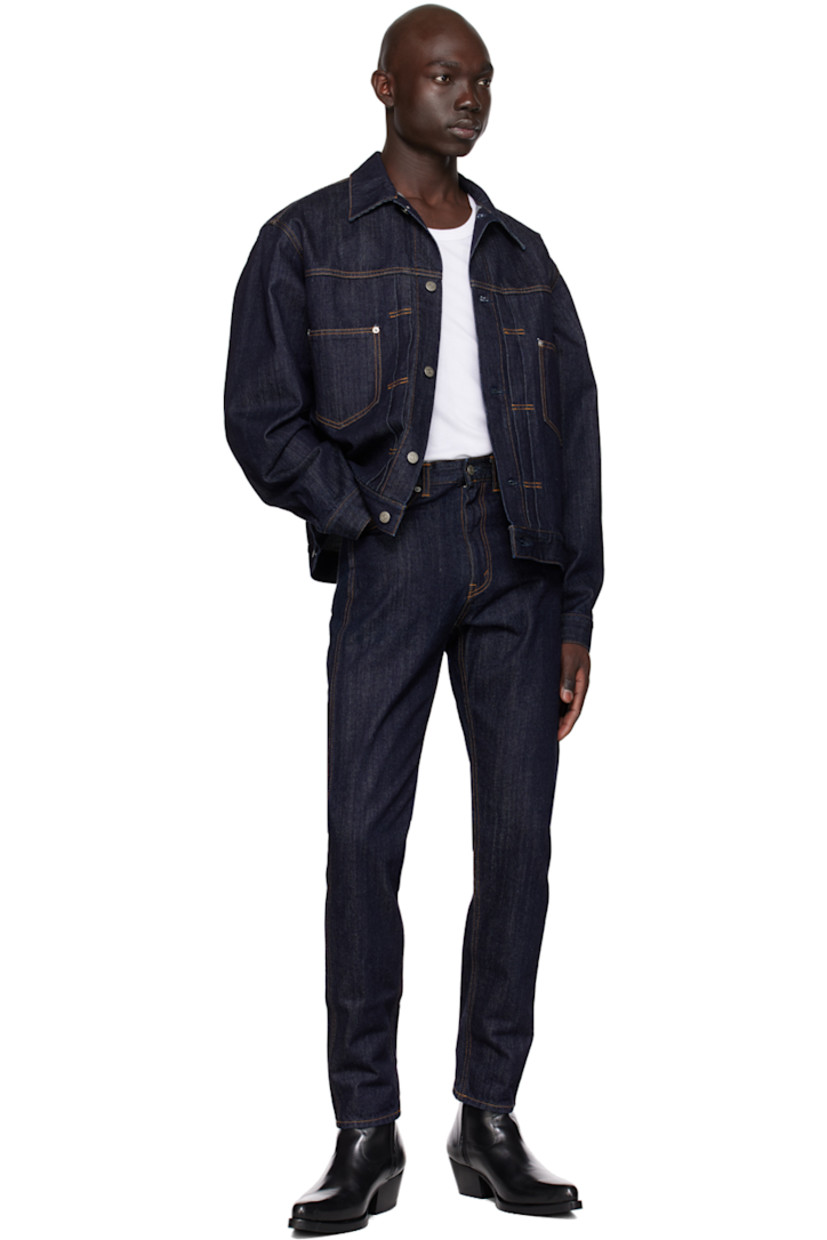 Tapered 11 oz non-stretch denim jeans.

· Belt loops
· Five-pocket styling
· Zip-fly
· Leather logo patch at back waistband
· Logo-engraved silver-tone hardware
· Contrast stitching in orange

Supplier color: Indigo