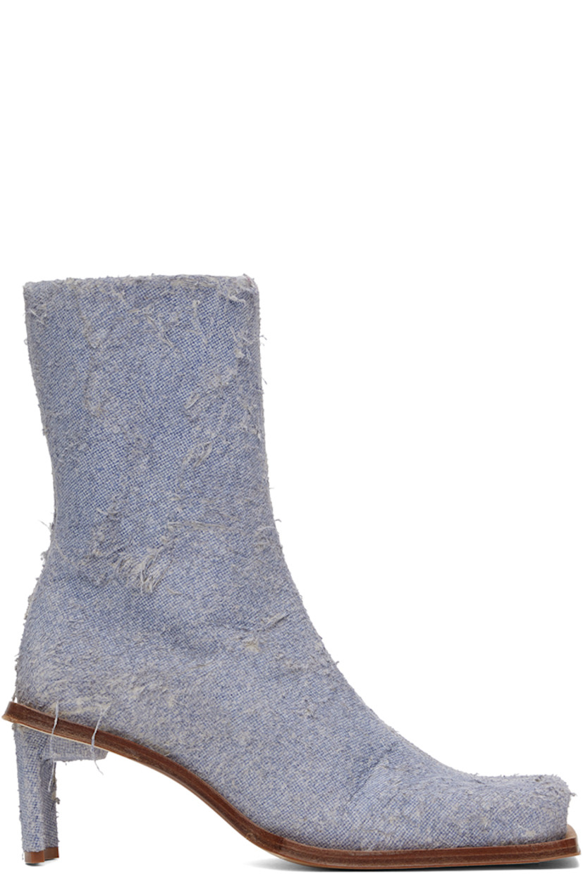 Handcrafted ankle-high non-stretch denim boots in blue.

· Hand-distressing throughout
· Square toe
· Concealed elasticized gusset at collar
· Zip closure at inner side
· Logo patch at memory foam insole
· Buffed calfskin lining
· Covered stiletto heel with rubber injection
· Leather sole with rubber injection
· Heel: H2.75"

Supplier color: Denim