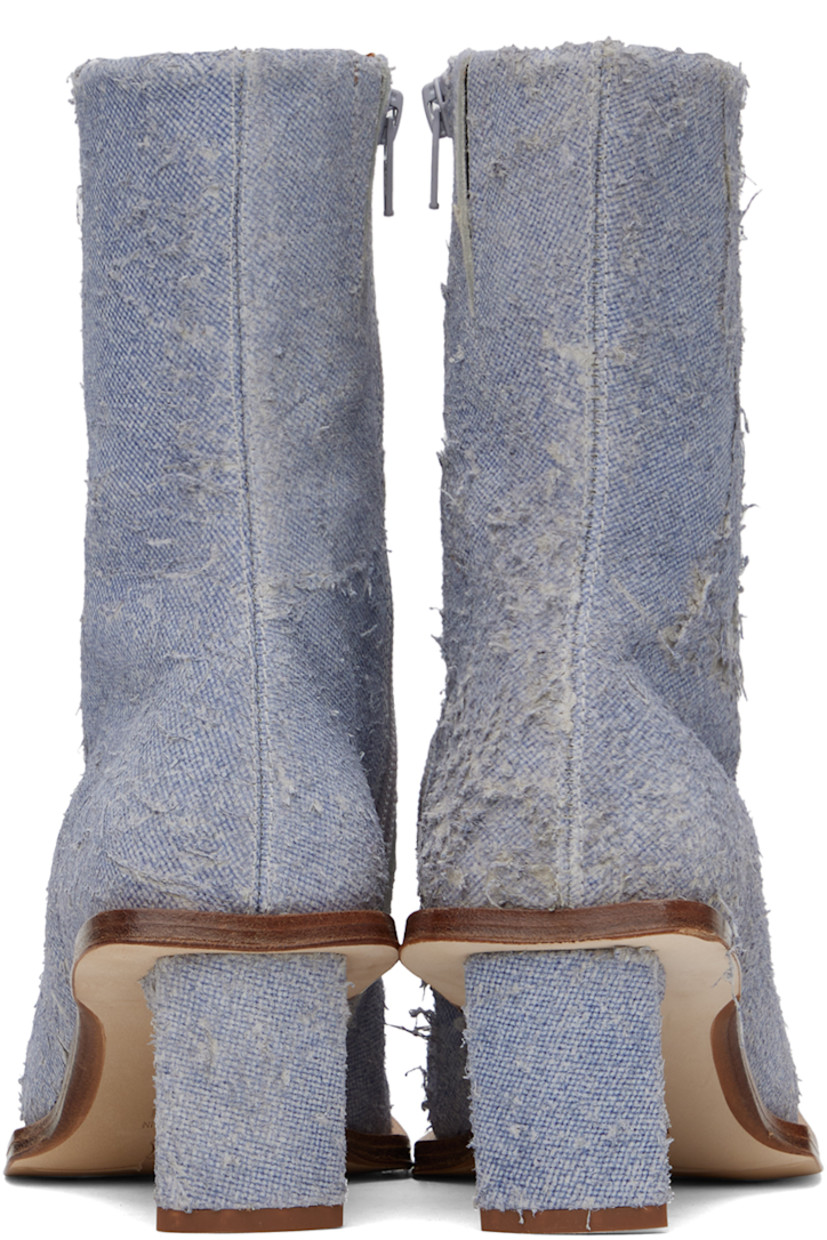 Handcrafted ankle-high non-stretch denim boots in blue.

· Hand-distressing throughout
· Square toe
· Concealed elasticized gusset at collar
· Zip closure at inner side
· Logo patch at memory foam insole
· Buffed calfskin lining
· Covered stiletto heel with rubber injection
· Leather sole with rubber injection
· Heel: H2.75"

Supplier color: Denim