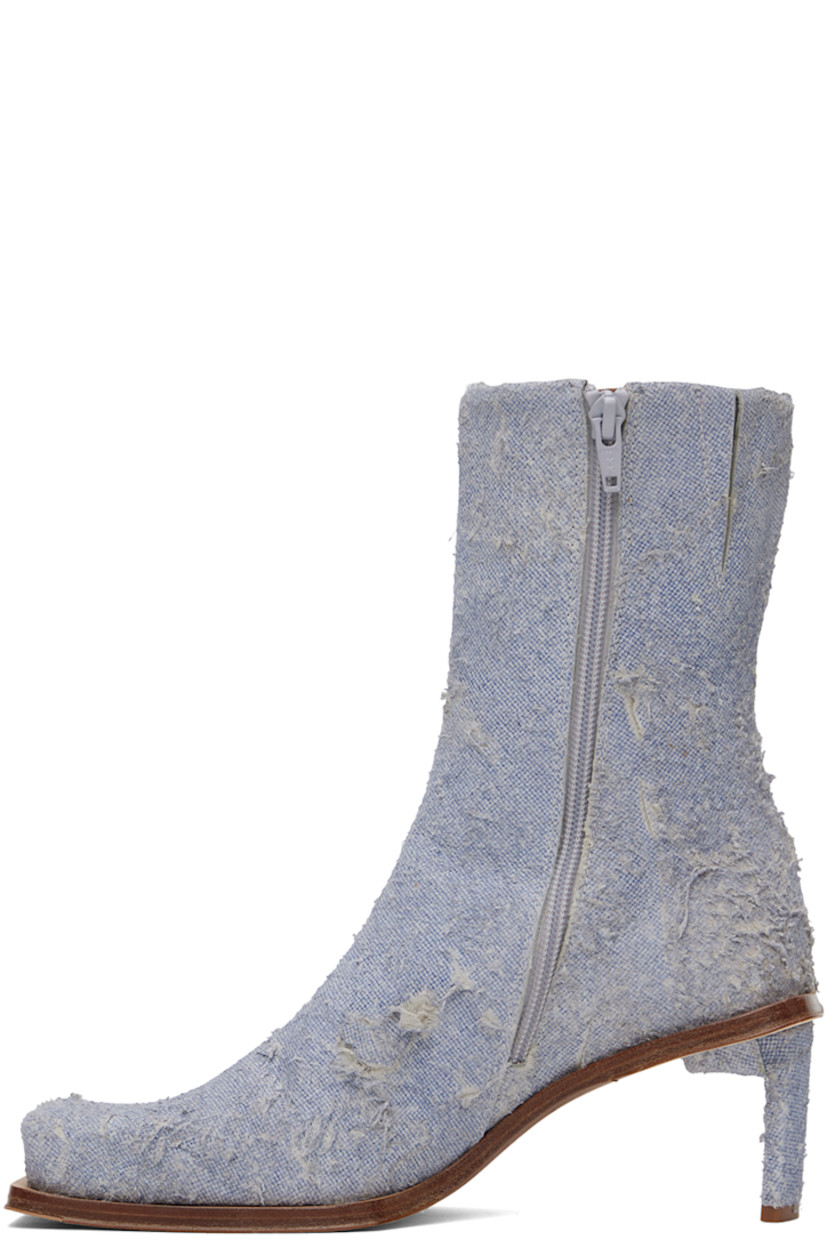 Handcrafted ankle-high non-stretch denim boots in blue.

· Hand-distressing throughout
· Square toe
· Concealed elasticized gusset at collar
· Zip closure at inner side
· Logo patch at memory foam insole
· Buffed calfskin lining
· Covered stiletto heel with rubber injection
· Leather sole with rubber injection
· Heel: H2.75"

Supplier color: Denim