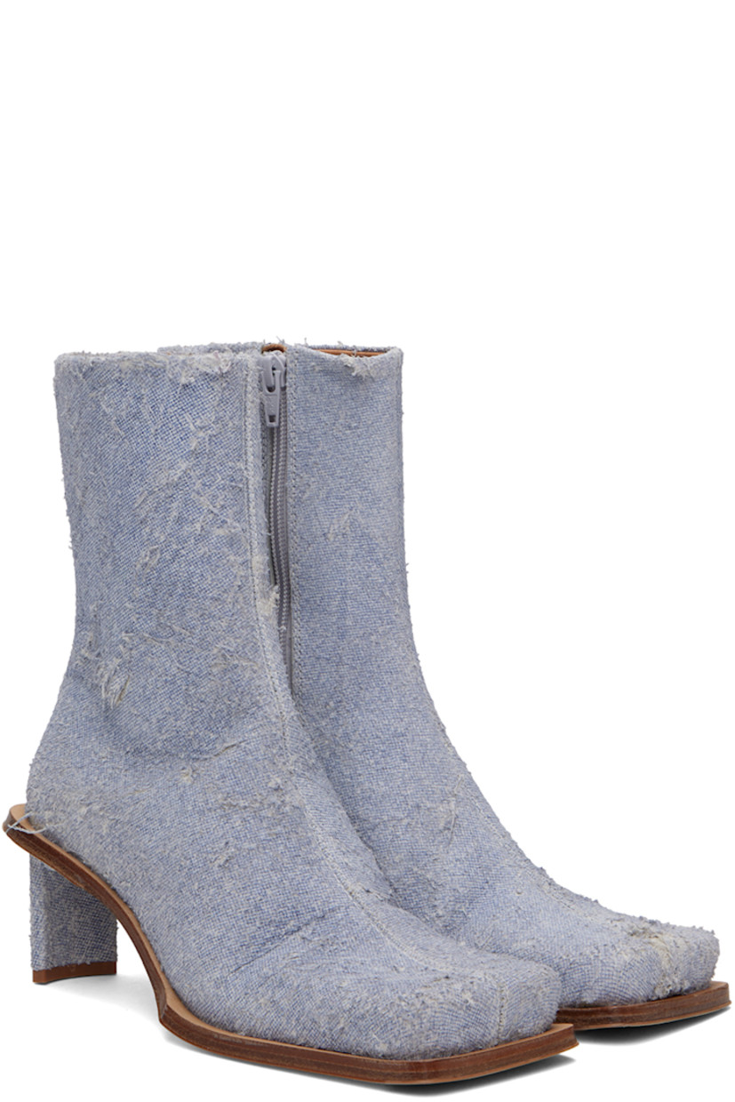 Handcrafted ankle-high non-stretch denim boots in blue.

· Hand-distressing throughout
· Square toe
· Concealed elasticized gusset at collar
· Zip closure at inner side
· Logo patch at memory foam insole
· Buffed calfskin lining
· Covered stiletto heel with rubber injection
· Leather sole with rubber injection
· Heel: H2.75"

Supplier color: Denim