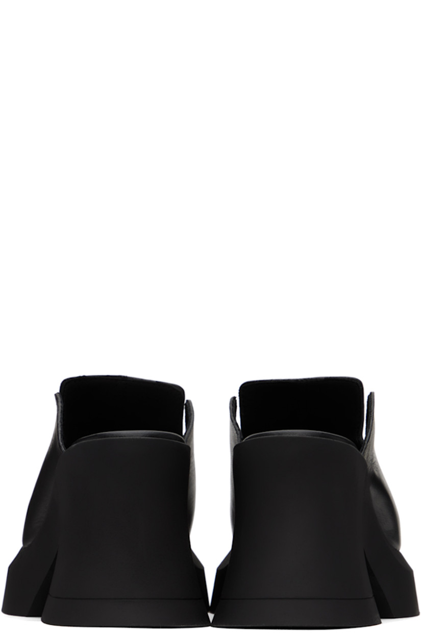 Handcrafted grained leather slip-on heels in black.

· Cutout at vamp
· Padded footbed
· Rubber block heel
· Rubber platform sole
· Platform: H1.5"
· Heel: H3.5"

Supplier color: Black