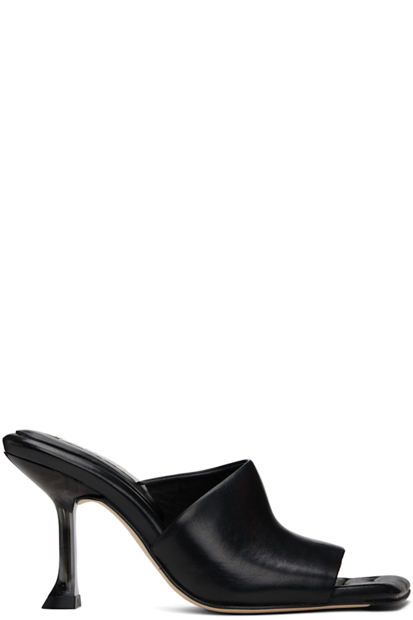 Grained leather mules in black.

· Open square toe
· Strap at vamp
· Padded grained leather footbed
· Semi-transparent plexiglass spool heel
· Suede sole with rubber injection
· Heel: H3.5"

Supplier color: Black