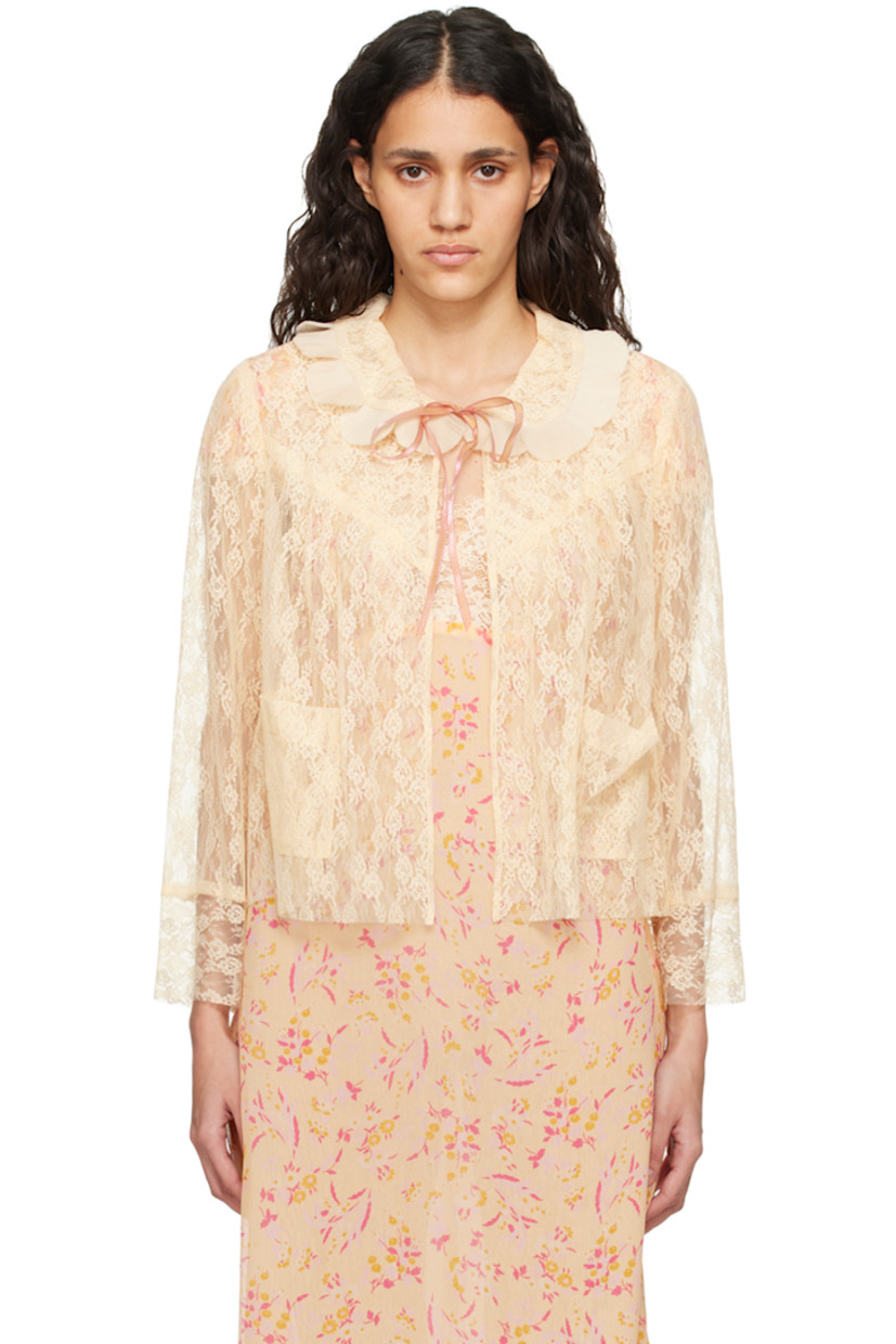 Sheer nylon lace blouse. Gathering and jacquard floral pattern throughout.

· Pleated ruffles at Peter Pan collar
· Self-tie closure
· Patch pockets
· Raw edge at hem and cuffs

Supplier color: Cantaloupe multi