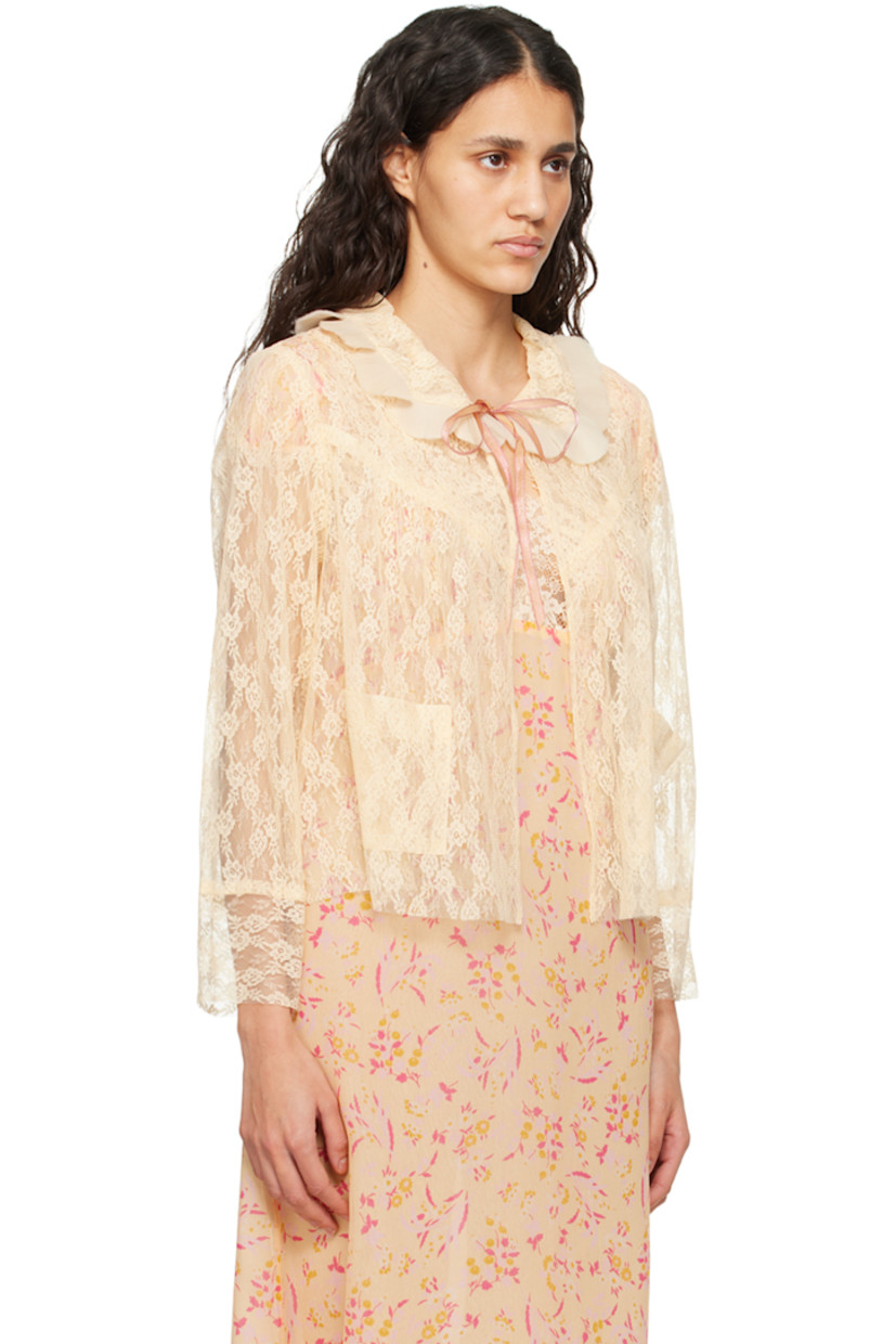 Sheer nylon lace blouse. Gathering and jacquard floral pattern throughout.

· Pleated ruffles at Peter Pan collar
· Self-tie closure
· Patch pockets
· Raw edge at hem and cuffs

Supplier color: Cantaloupe multi