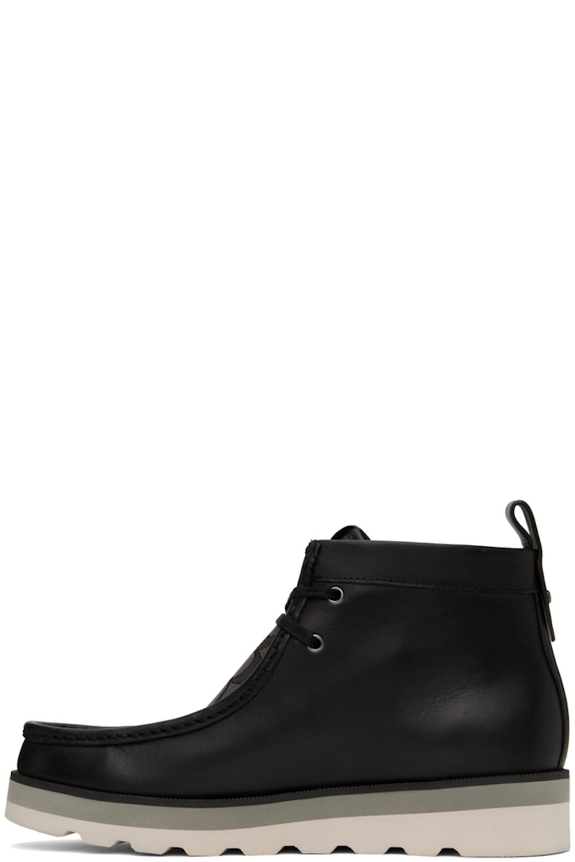 Ankle-high paneled coated canvas and buffed leather boots in black.

· Moc toe
· Lace-up closure
· Jacquard logo pattern at vamp
· Leather logo patch at bellows tongue
· Pull-loop at back collar
· Logo hardware at heel tab
· Logo-embossed at padded footbed
· Faux-leather lining
· EVA foam midsole
· Treaded foam rubber sole
· Silver-tone hardware

Supplier color: Black