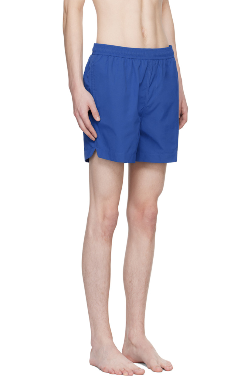 Nylon ripstop swim shorts. 

· Drawstring at elasticized waistband
· Three-pocket styling
· Mock-fly
· Rubberized logo patch at front
· Vented outseams
· Partial polyester mesh lining

Supplier color: Volt blue
