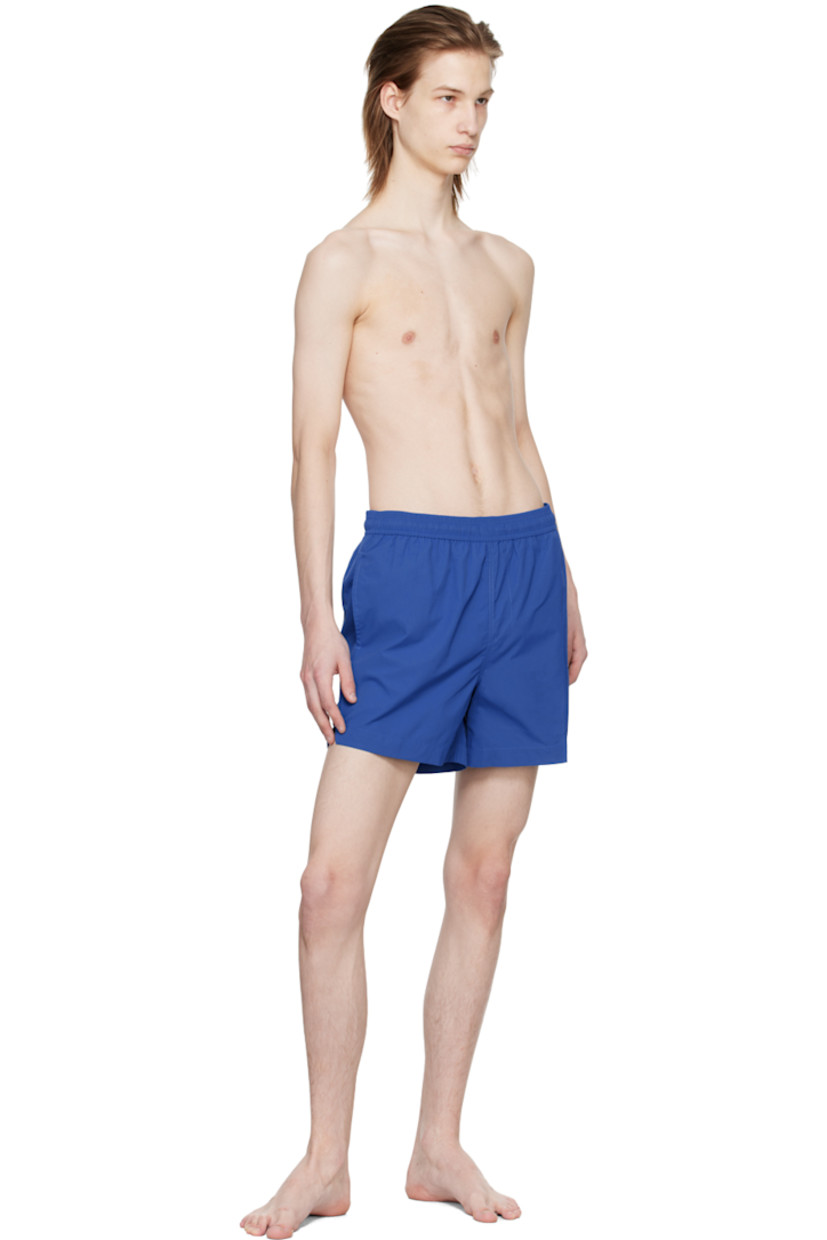 Nylon ripstop swim shorts. 

· Drawstring at elasticized waistband
· Three-pocket styling
· Mock-fly
· Rubberized logo patch at front
· Vented outseams
· Partial polyester mesh lining

Supplier color: Volt blue