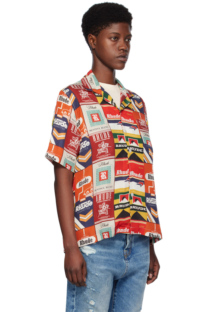 Silk satin shirt. Logo graphic printed throughout. 

· Open spread collar 
· Button closure 
· Patch pocket 
· Tennis-tail hem 

Supplier color: Red multi