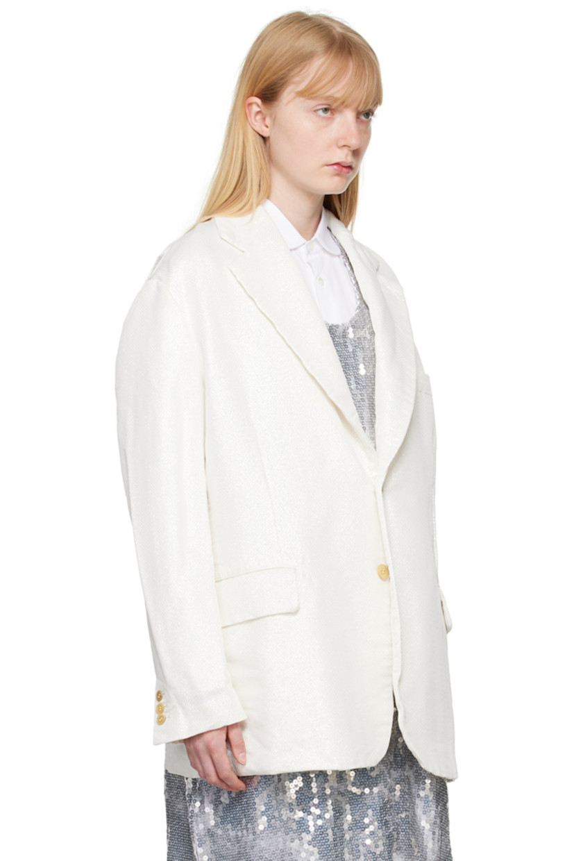 Garment-treated polyester lamé blazer. Herringbone pattern and metallic thread detailing throughout.

· Notched lapel
· Button closure
· Welt pocket at chest
· Flap pockets
· Three-button surgeon's cuffs
· Cutout and raw edges at back armscyes
· Central vent at back hem
· Partial plain-woven lining

Supplier color: White