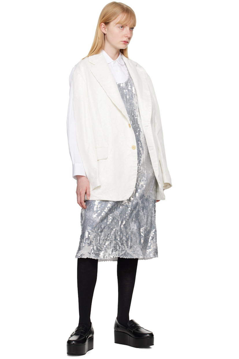 Garment-treated polyester lamé blazer. Herringbone pattern and metallic thread detailing throughout.

· Notched lapel
· Button closure
· Welt pocket at chest
· Flap pockets
· Three-button surgeon's cuffs
· Cutout and raw edges at back armscyes
· Central vent at back hem
· Partial plain-woven lining

Supplier color: White