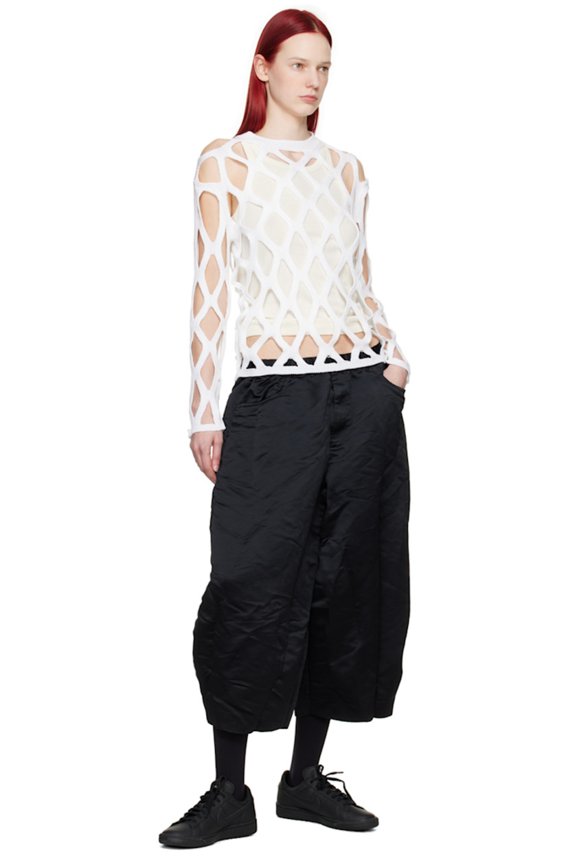 Knit acrylic sweater.

· Cutouts throughout
· Rib knit crewneck, hem, and cuffs

Supplier color: White