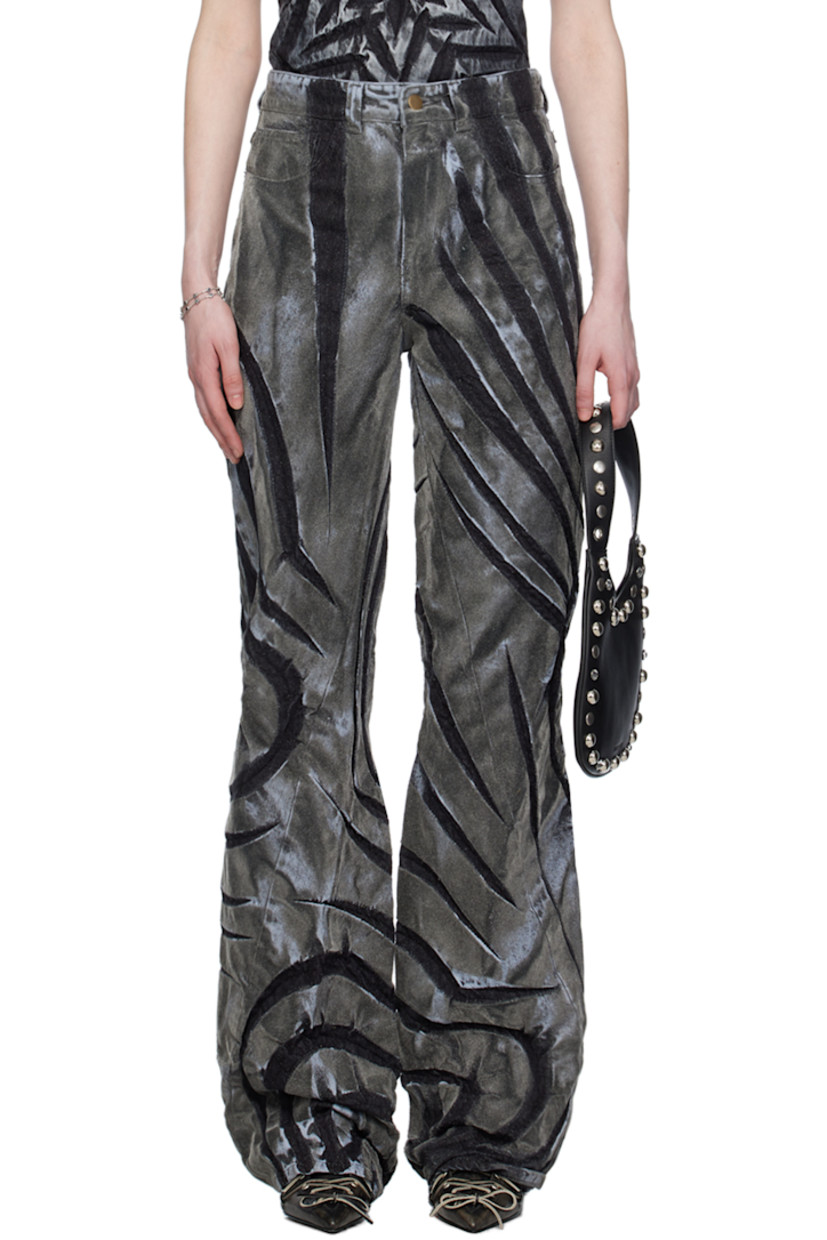 Non-stretch denim jeans. Fading, creasing, and graphic pattern flocked throughout. 

· Belt loops
· Five-pocket styling
· Zip-fly
· Asymmetrical cuffs 

Supplier color: Dark silver