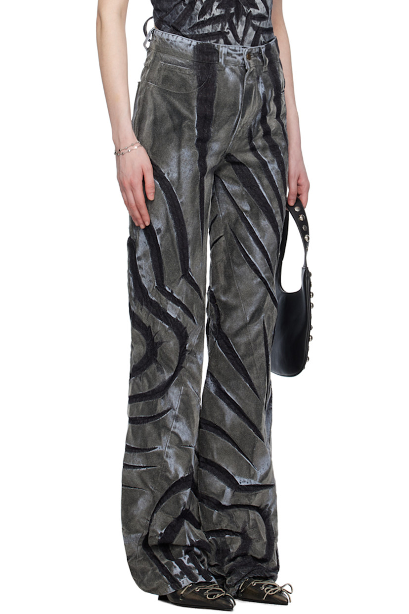 Non-stretch denim jeans. Fading, creasing, and graphic pattern flocked throughout. 

· Belt loops
· Five-pocket styling
· Zip-fly
· Asymmetrical cuffs 

Supplier color: Dark silver