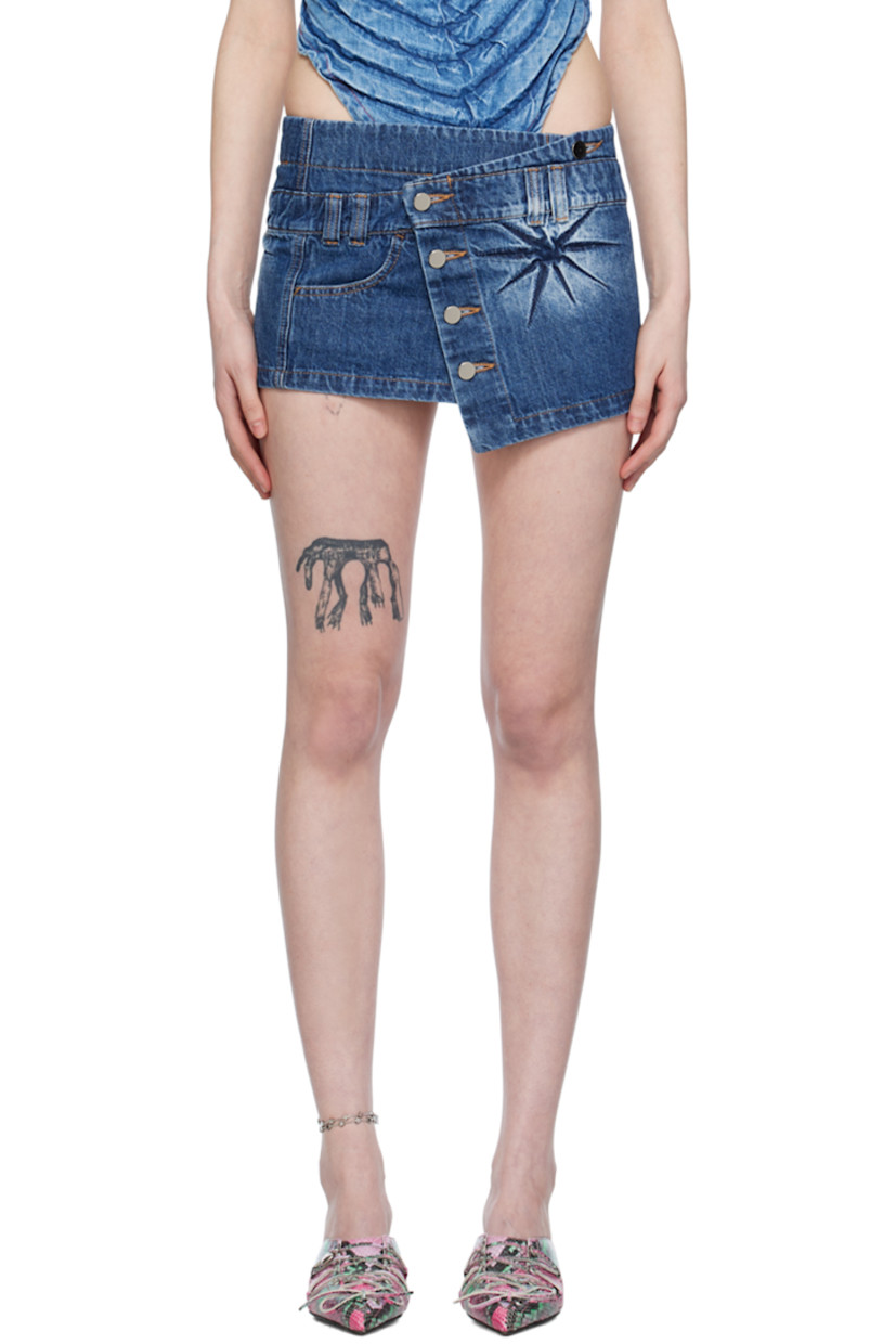 Non-stretch denim skirt. Fading and creasing throughout. 

· Belt loops
· Offset button closure 
· Welt pocket
· Contrast stitching in tan

Supplier color: Indigo
