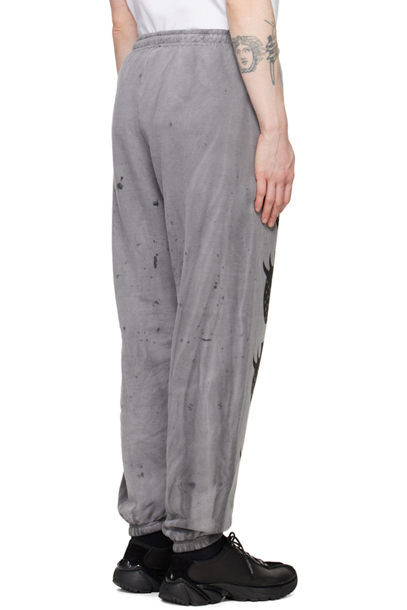 Handcrafted cotton- and polyester-blend fleece lounge pants. 

· Fading, paint splatter effect, and graphics printed throughout
· Elasticized waistband and cuffs

Each item is unique. Please note that finishings may vary.

Supplier color: Dirty charcoal