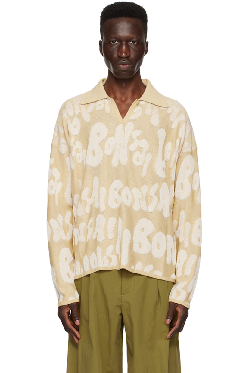 Knit cotton- and rayon-blend polo. Jacquard logo pattern throughout.

· Rib knit spread collar, hem, and cuffs
· Single-button placket
· Dropped shoulders

Supplier color: Almond oil