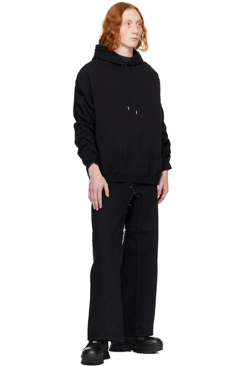 French terry hoodie.

· Drawstring at hood
· Welt pockets
· Rib knit hem and cuffs
· Dropped shoulders
· Ruching at sleeves
· Bungee-style drawstring at back collar

Supplier color: Black