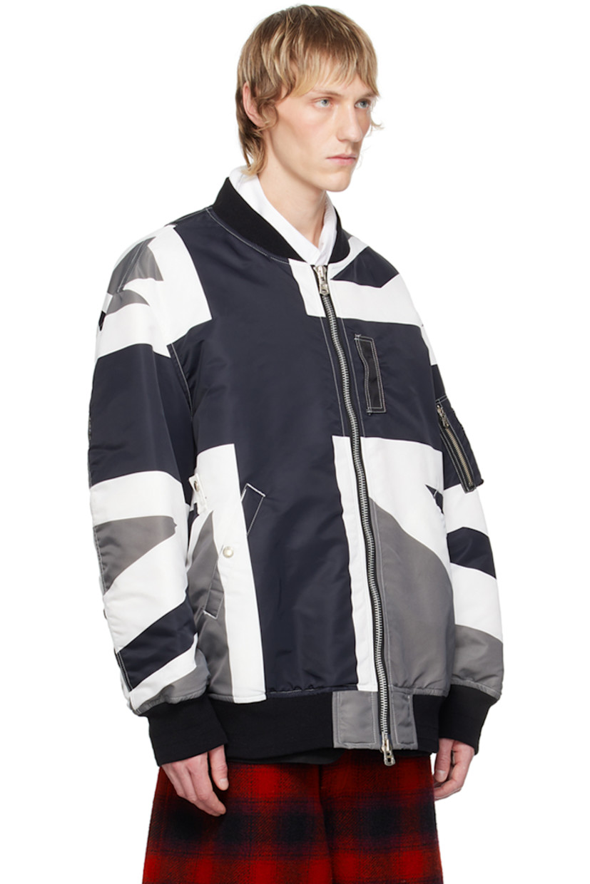 Padded nylon twill bomber jacket. Graphic printed throughout.

· Rib knit stand collar, hem, and cuffs
· Two-way zip closure
· Press-stud tab at front
· Welt pockets
· Utility pocket at sleeve
· Gusset at back sleeves
· Welt pockets at interior
· Full twill lining

Supplier color: Monotone