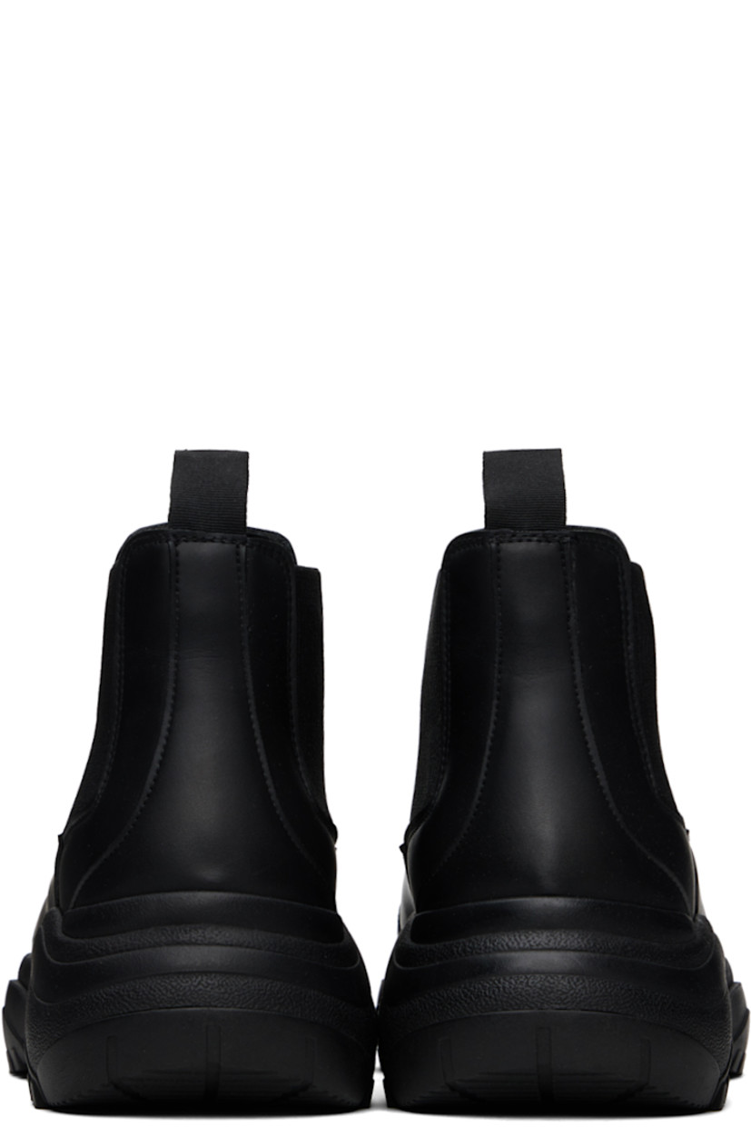 Ankle-high buffed apple- and polyurethane-blend faux-leather Chelsea boots in black.

· Logo-embossed rubber trim at toe
· Elasticized gusset at sides
· Webbing pull-loop at heel collar
· Buffed faux-leather lining
· Treaded rubber sole

Supplier color: Black apple pam