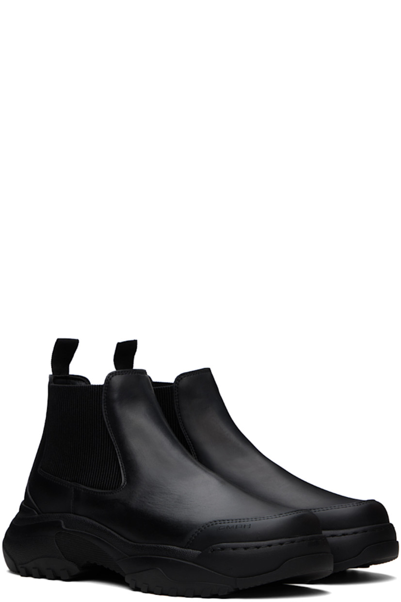 Ankle-high buffed apple- and polyurethane-blend faux-leather Chelsea boots in black.

· Logo-embossed rubber trim at toe
· Elasticized gusset at sides
· Webbing pull-loop at heel collar
· Buffed faux-leather lining
· Treaded rubber sole

Supplier color: Black apple pam