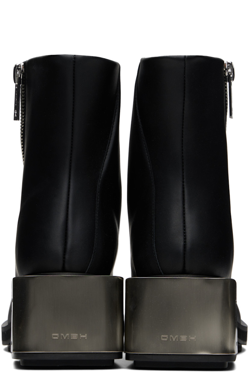Ankle-high buffed faux-leather boots in black.

· Offset zip closure at vamp
· Logo plaque at block heel
· Foam rubber midsole
· Faux-leather sole with rubber injections
· Logo-engraved silver-tone hardware
· Heel: H2.25"

Supplier color: Black apple pam